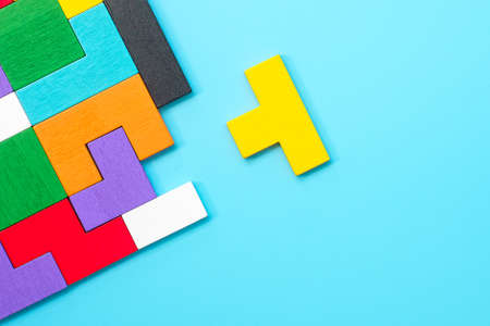 colorful wood puzzle pieces on blue background, geometric shape block. Concepts of logical thinking, Conundrum, solutions, rational, strategy, world logic day and Educationの写真素材