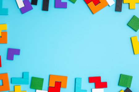 colorful wood puzzle pieces on blue background, geometric shape block with copy space. Concepts of logical thinking, Conundrum, solutions, rational, strategy, world logic day and Educationの写真素材