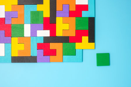 colorful wood puzzle pieces on blue background, geometric shape block. Concepts of logical thinking, Conundrum, solutions, rational, strategy, world logic day and Educationの写真素材