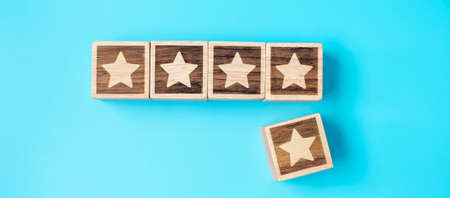 star symbol block on blue background. Service rating, ranking, customer review, satisfaction, evaluation and feedback conceptの写真素材