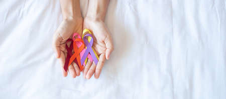 World cancer day (February 4). colorful awareness ribbons; red, orange, purple, pink and yellow color for supporting people living and illness. Healthcare and medical conceptの写真素材