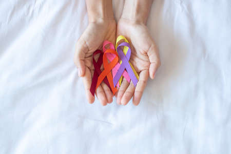 World cancer day (February 4). colorful awareness ribbons; red, orange, purple, pink and yellow color for supporting people living and illness. Healthcare and medical conceptの写真素材