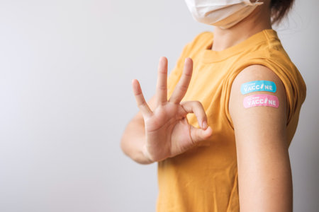 woman showing OK sign with bandageの写真素材
