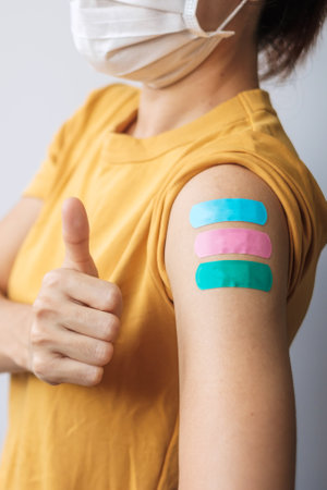 woman showing Thumb sign with bandageの写真素材