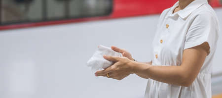 woman clean hand by wet wipe tissue in public transportationの写真素材
