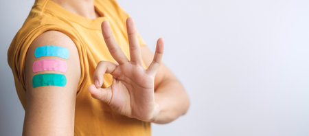 woman showing Thumb sign with bandageの写真素材