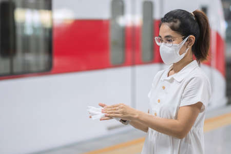woman clean hand by wet wipe tissue in publicの写真素材