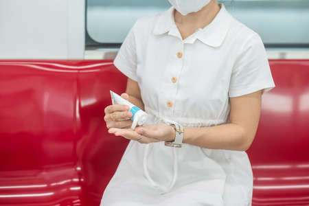 woman clean hand by alcohol gel sanitizerの写真素材
