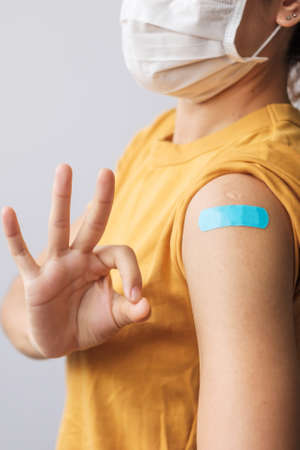 woman showing OK sign with bandageの写真素材