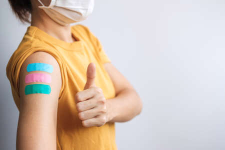 woman showing Thumb sign with bandageの写真素材