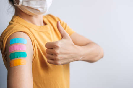 woman showing Thumb sign with bandage