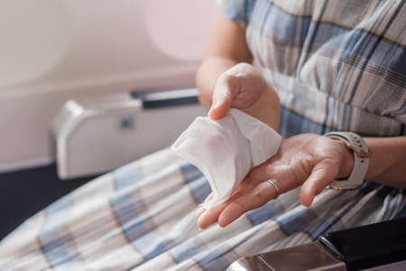 woman clean seat by wet wipe tissue  in public transportationの写真素材