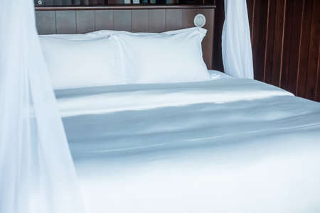 Clean Pillows on bed in luxury hotel room or modern home. Sleeping, Relax and vacation concepts