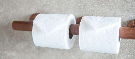 Woman hand pulling toilet paper in restroom. Cleaning, Lifestyle and personal hygiene conceptの写真素材