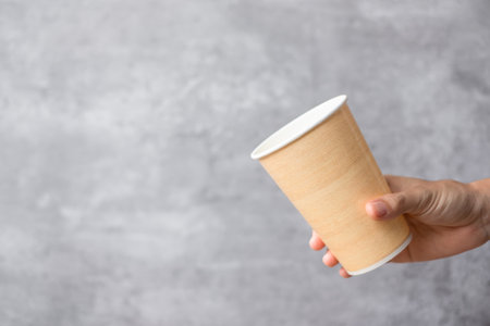 Eco friendly food packaging or takeaway coffee cup. Hand holding natural container for to go. zero waste, pollution, earth day, free plastic, world Environment day conceptの写真素材