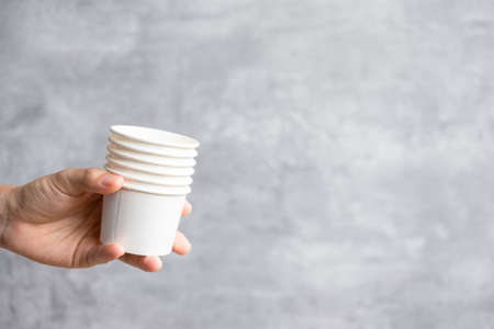 Eco friendly food packaging or takeaway coffee cup. Hand holding natural container for to go. zero waste, pollution, earth day, free plastic, world Environment day conceptの写真素材