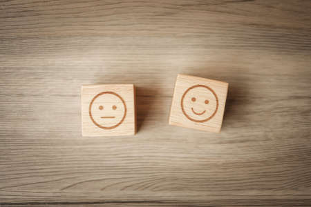 emotion face symbol on wooden blocks. mood, Service rating, ranking, customer review, satisfaction, evaluation and feedback conceptの写真素材