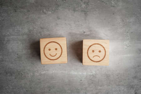 emotion face symbol on wooden blocks. mood, Service rating, ranking, customer review, satisfaction, evaluation and feedback conceptの写真素材