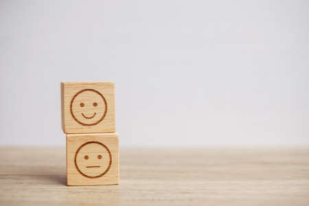 emotion face symbol on wooden blocks. mood, Service rating, ranking, customer review, satisfaction, evaluation and feedback conceptの写真素材