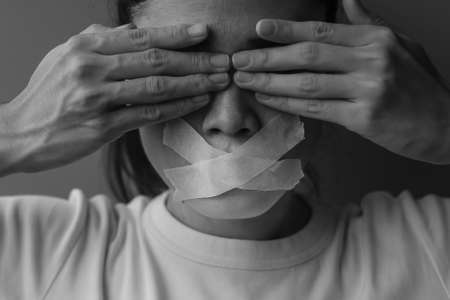 woman with mouth sealed in adhesive tape. Free of speech, freedom of press, Human rights, Protest dictatorship, democracy, liberty, equality and fraternity conceptsの写真素材