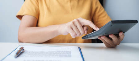 Woman using calculator. Contract agreement, rental finance and accounting concepts