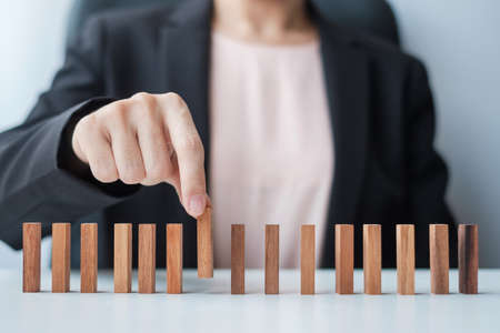 Businesswoman hand pulling leader man wooden from crowd of block. Toxic People, Human resource management, Recruitment, Teamwork and leadership Conceptsの写真素材