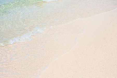 Soft wave of blue sea water and white sand at Beautiful beach. Background, wallpaper and abstract...
