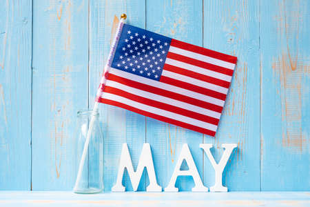 MAY text and United States of America flag on wooden table background. happy Memorial day and...
