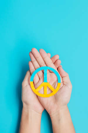 Support for Ukraine in the war with Russia, Hands holding symbol of peace with flag of Ukraine....