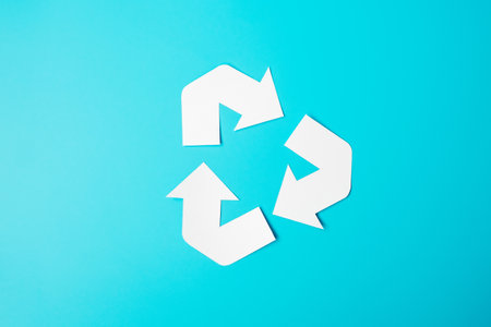 Paper Recycle logo cutout on blue background. Environmental Protection, Zero waste, Reusable, Say No Plastic, World Environment day, Ecology day and Earth day concept.の写真素材