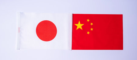 Japan against China flags. Sanctions, war, conflict, Politics and relationship conceptの写真素材