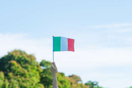 hand holding Italy flag on nature background. National Day, Republic Day, Festa della Repubblica and happy celebration conceptsの写真素材