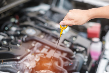 woman hand  check oil level in car engine. Self Maintenance, repair and problem concept