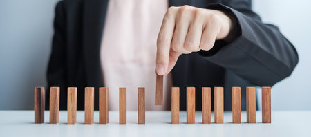 Businesswoman hand pulling leader man wooden from crowd of block. Toxic People, Human resource management, Recruitment, Teamwork and leadership Conceptsの写真素材