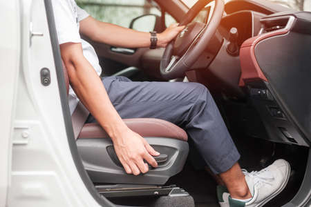 Hand adjust car seat before drive on the road . Ergonomic and safety transportation conceptの写真素材