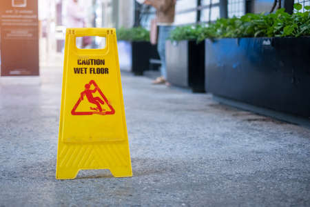 Sign showing warning of caution wet floor in office buildingの写真素材