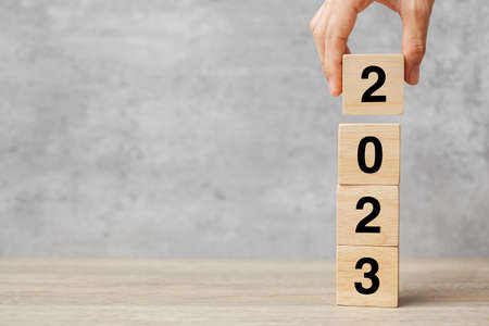 hand holding block 2023 text on table. Resolution, strategy, plan, goal, motivation, reboot, business and New Year holiday conceptsの写真素材