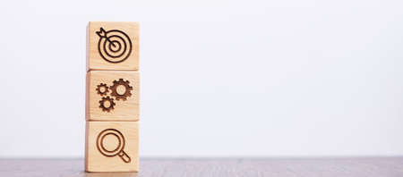 wood block with business goal, strategy, target, mission, action, objective, teamwork, brainstorm...