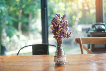 Beautiful Dried statice or Sea Lavender flower Limonium spp. in glass jar on wooden table. for background with blank copy spaceの写真素材