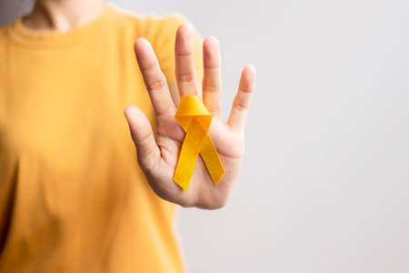Suicide prevention day, Childhood, Sarcoma, bone and bladder cancer Awareness month, Yellow Ribbon for supporting people life and illness. Healthcare and World cancer day conceptの写真素材