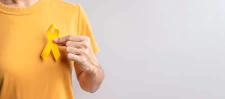 Suicide prevention day, Childhood, Sarcoma, bone and bladder cancer Awareness month, Yellow Ribbon for supporting people life and illness. Healthcare and World cancer day conceptの写真素材