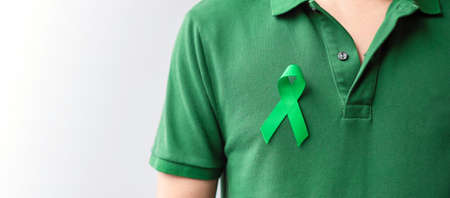 green Ribbon for Liver, Gallbladders, bile duct, cervical, kidney Cancer and Lymphoma Awareness month. Healthcare and world cancer day conceptの写真素材
