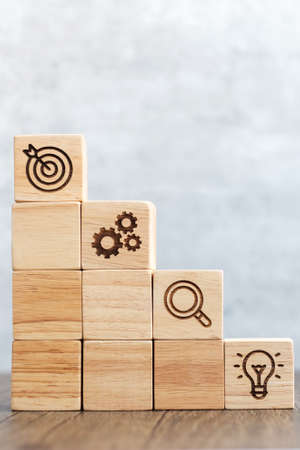 wood block stack of building with business goal, strategy, target, mission, action, objective, teamwork, research and idea conceptの写真素材