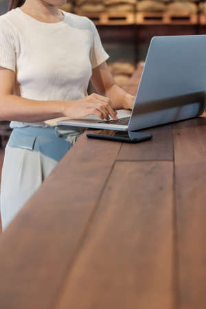 Casual Businesswoman using laptop, freelance woman typing keyboard computer notebook in cafe or modern office. technology, digital online and network conceptの写真素材