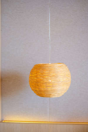 Bamboo lamp hanging in bedroom. Scandinavian, minimal and bohemian style