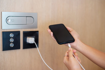 Hand Charging battery on mobile smartphone. Technology, multiple sharing and recharge conceptsの写真素材