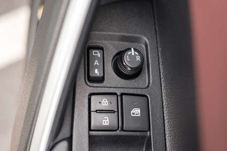 buttons controlling the windows inside a car, control and electric mirror adjustment
