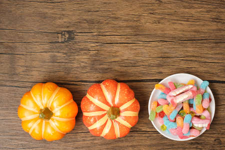 Happy Halloween day with ghost candies, pumpkin,  bowl and decorative. Trick or Threat, Hello...