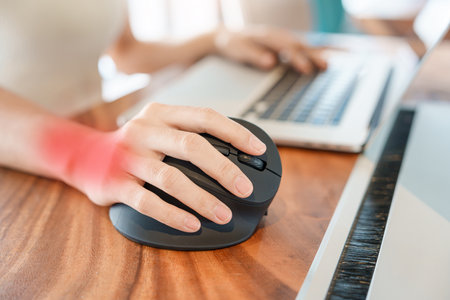woman hand using computer ergonomic mouse, prevention wrist pain because working long time. De Quervain s tenosynovitis, Intersection Symptom, Carpal Tunnel Syndrome or Office syndrome conceptの写真素材