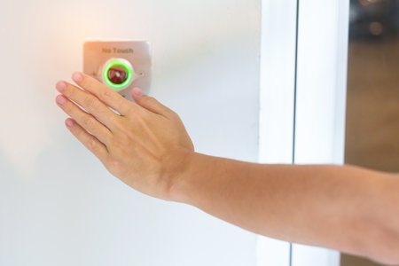 Hand open the door by No touch sensor switch on the wall at office or apartment. Contactless,...